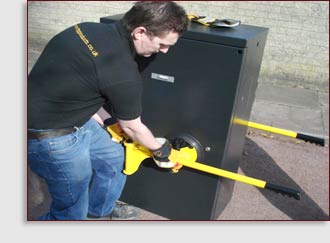 2 men using cabilft to lift traffic signal cabinet