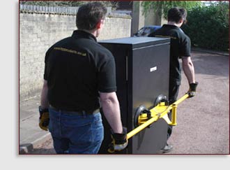 2 men using cabilft to lift traffic signal cabinet